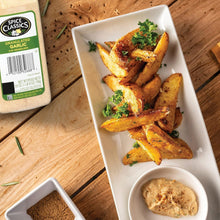Spice Classics granulated garlic container beside seasoned potato wedges and herbs