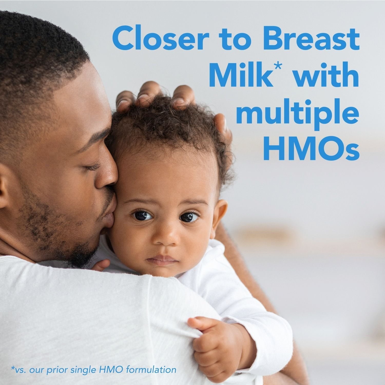 Parent holding baby with blue 'Closer to Breast Milk' multi HMO marketing text