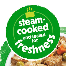Steam-cooked and sealed for freshness wet dog food meal, bowl close-up