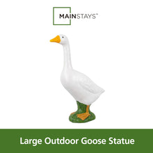 Garden goose statue standing upright with yellow beak and green base.