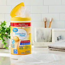 Lemon-scent disinfecting wipes canister on table, white lid pouch visible