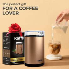 Electric coffee grinder in copper with clear lid and black bottom ring