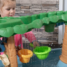 Blue plastic dino water table with green canopy and water-stream toys