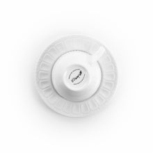 Ceramic mug base and saucer underside with embossed rim and small logo stamp