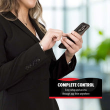 Person holding smartphone to control a black robot vacuum