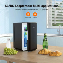 Black compact mini fridge with side AC/DC power adapter connected