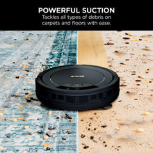 Robot vacuum on dual-surface floor with scattered debris, top view