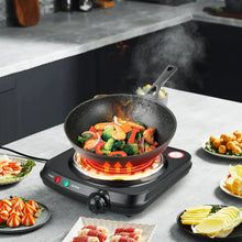 Single coil electric hot plate heating a skillet with steam rising during cooking