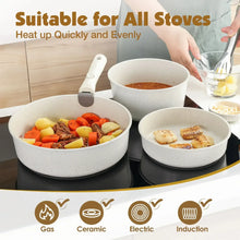 White speckled pots and pans with detachable handles arranged on a stovetop