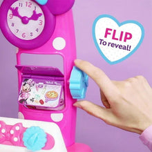 Pink pretend play kitchen stove with flip-reveal door and hand opening the window