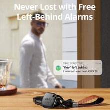 Black key finder tag with keys on a table
