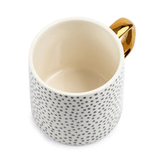 14 fl oz dot stoneware mug with off-white interior, black speckles, and gold-tone handle