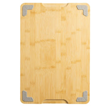 Bamboo cutting board with corner grip pads and juice-groove channel, light natural finish