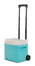 Aqua hard-sided ice chest cooler with white lid and upright telescoping handle