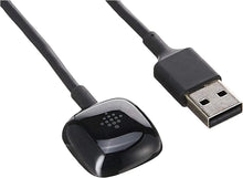 Black charging puck and USB-A connectors on cable, angled close-up.