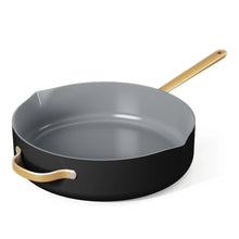 Black ceramic sauté pan with strainer lid and gray nonstick interior