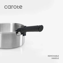 Stainless steel saucepan with removable black handle attached