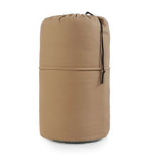 Tan cold-weather sleeping bag rolled in a compact storage cover with drawstring