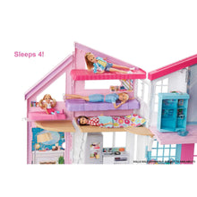 Open dollhouse playset with upper beds, living area, and doorway with furniture