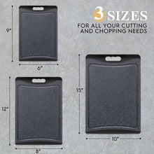 Square dark grey cutting boards set with hanging holes in three different sizes.
