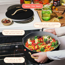 Black ceramic nonstick stock pot with strainer lid and side handle, inside oven