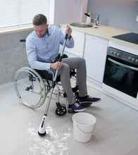 Cordless spin scrubber with long handle and rotating brush head for floor cleaning