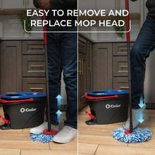 Spin mop bucket with microfiber mop head being removed and replaced on wringer base