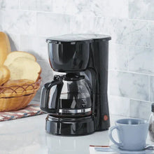 5-cup drip coffee maker in black with carafe, handle, and top reservoir lid