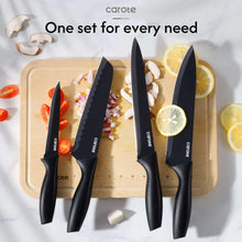 Black ceramic-coated knife set arranged with knives and a wooden cutting board