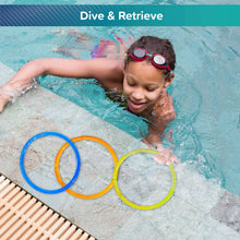 Three multi-color sparkly pool dive rings resting on the pool edge