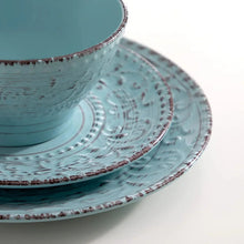Blue stoneware bowl with embossed concentric pattern and speckled finish.