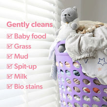 Dreft baby laundry detergent shown with baby clothes and a purple hamper grid basket.