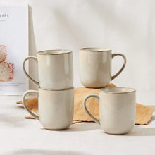 Cream ceramic coffee mugs with handles, four-piece set, stacked arrangement