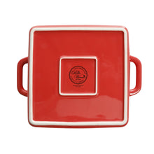 Square ceramic baking dish bottom with red glaze, white trim, and small logo seal