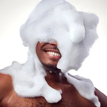 Foaming body wash covering a man’s face and upper body