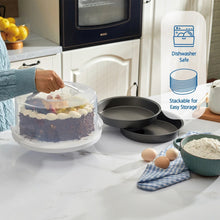 Clear cake carrier with gray round pans on countertop