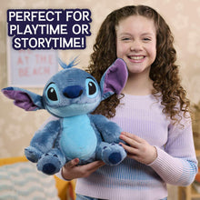 Blue plush alien character with purple ears and a blue antenna tuft, held in arms.