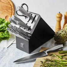 Self-sharpening knife block with several gray knives and a chef knife on counter