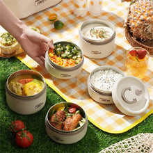 White insulated food containers with lids open, showing multiple meal portions inside