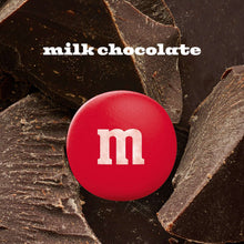 Red M&M milk chocolate candy on dark chocolate pieces