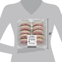 Frosted sugar cookie package held on person with 8 inch height reference
