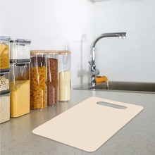 Beige chopping board mat on counter with handle slot