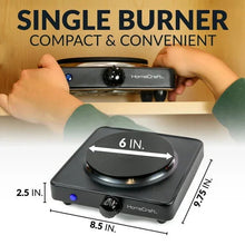 Single-burner hot plate held above counter, compact black cooktop with round coil