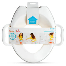 Toddler potty seat in retail box with built-in side handles, light-colored