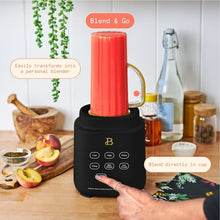 Black blender base with clear jar fitted with red Blend & Go cup attachment
