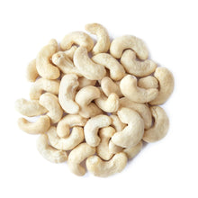 Whole raw cashew nuts heap, pale cream color