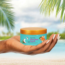 Exfoliating sugar scrub jar in hand, turquoise container with orange lid