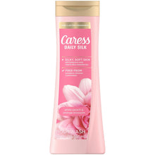 Caress Daily Silk body wash bottle with gold cap, white peach & orange blossom scent