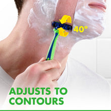 Disposable razor with green handle and blue head shaving along skin contours.