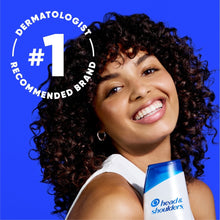 Head & Shoulders 2-in-1 Men bourbon scent bottle held by smiling person